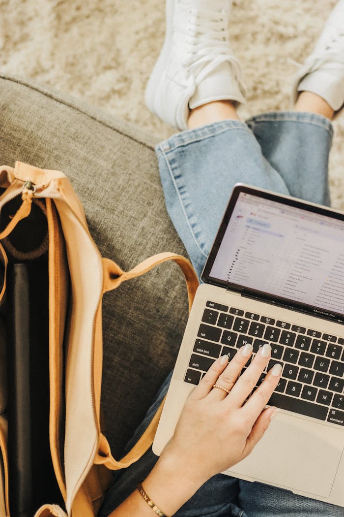 why-choose-us A person using a laptop with an elegant tote bag nearby in a casual setting.